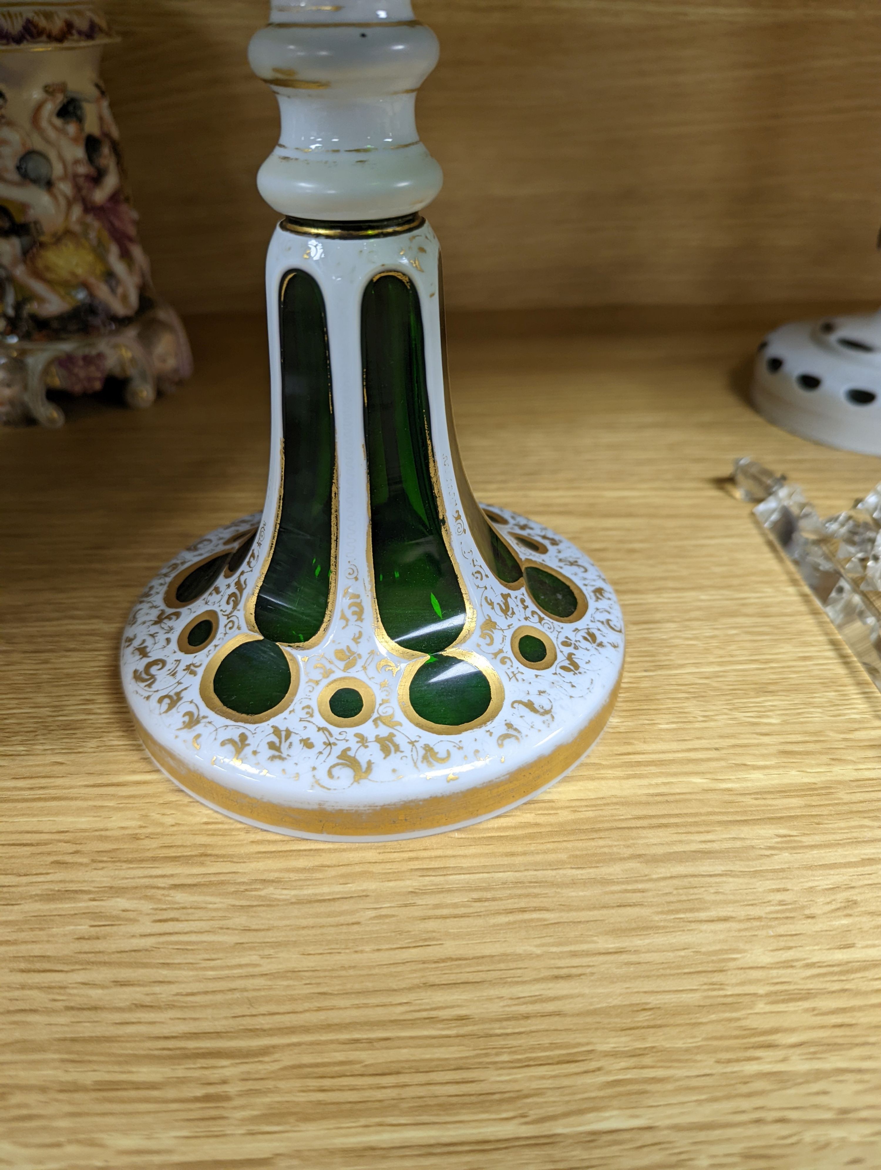 A 19th century overlaid green glass comport, 24cm high, and a similar table lustre